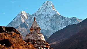 Ancient Buddhist Stupa Framing Snow-Capped Himalayan Peak Under Clear Blue Sky HD wallpaper