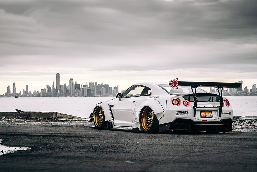 White Nissan GT-R R35 with Liberty Walk Widebody and Gold Wheels Parked on a Pier in New York City HD wallpaper