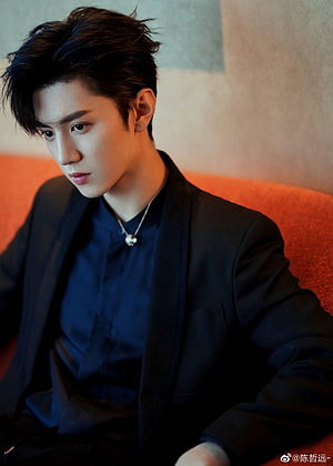 Chen Zhe Yuan in a black suit and navy shirt with a pendant necklace HD phone wallpaper