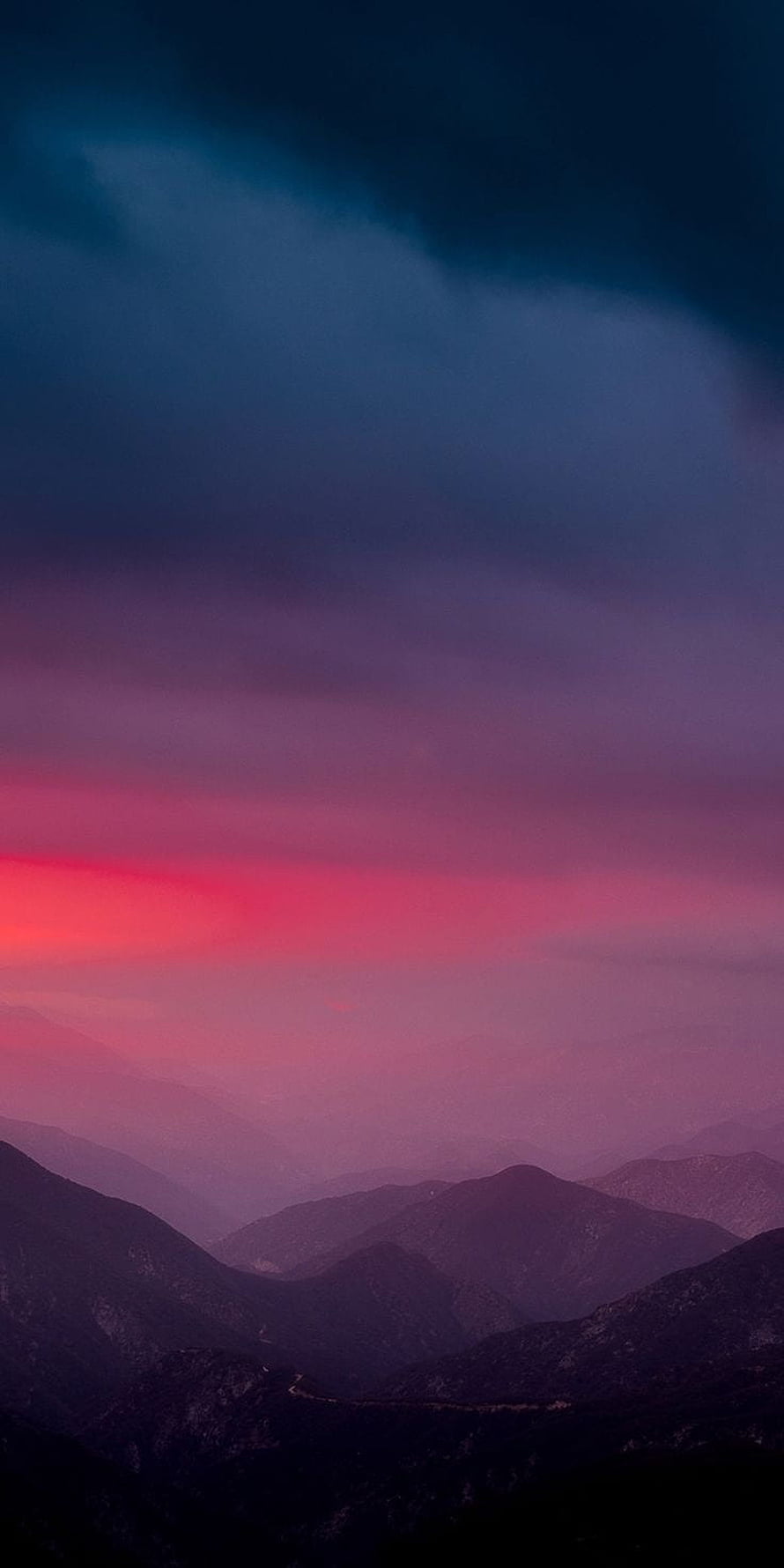 Vibrant pink and purple sunset sky over layered mountain ridges at dusk HD phone wallpaper