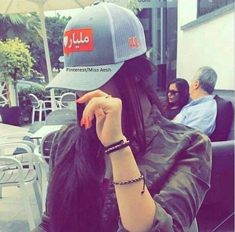 Girl in Grey Cap and Camouflage Jacket at Outdoor Cafe HD wallpaper