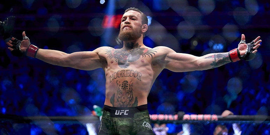 Conor McGregor Celebrates Victory in UFC Octagon with Arms Wide Open HD wallpaper