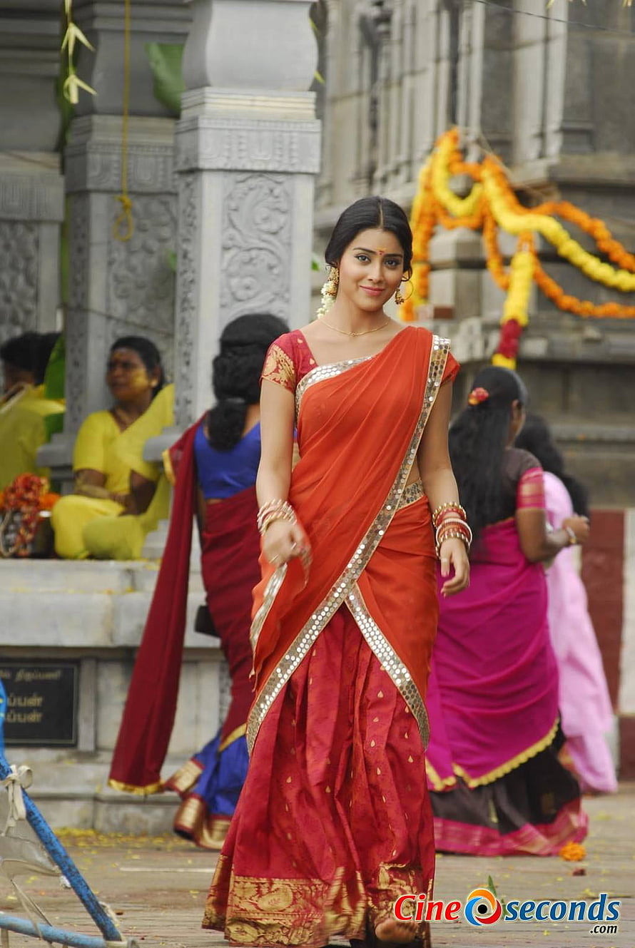 Shriya Saran in a red silk saree at a temple during a traditional festival HD phone wallpaper
