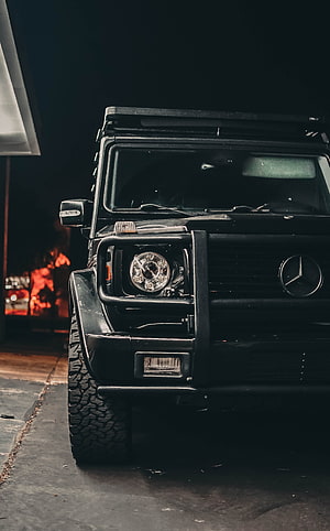 Black Mercedes G-Class SUV Front View at Night with Bull Bar and Off-Road Tires HD phone wallpaper