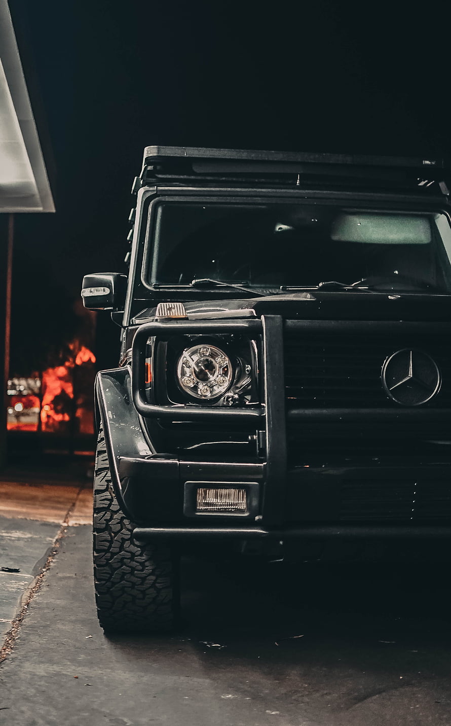 Black Mercedes G-Class SUV Front View at Night with Bull Bar and Off-Road Tires HD phone wallpaper