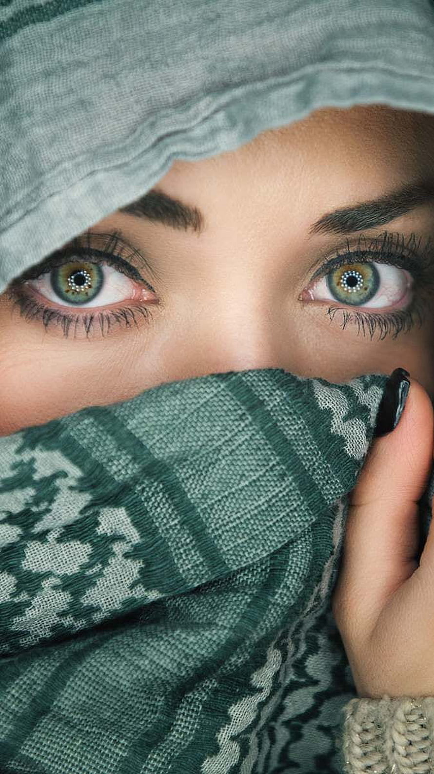 Close-up portrait of a woman wearing a patterned hijab with striking green eyes HD phone wallpaper
