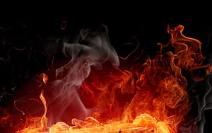 Vibrant Orange Flames and Billowing Smoke Against a Deep Black Background HD wallpaper