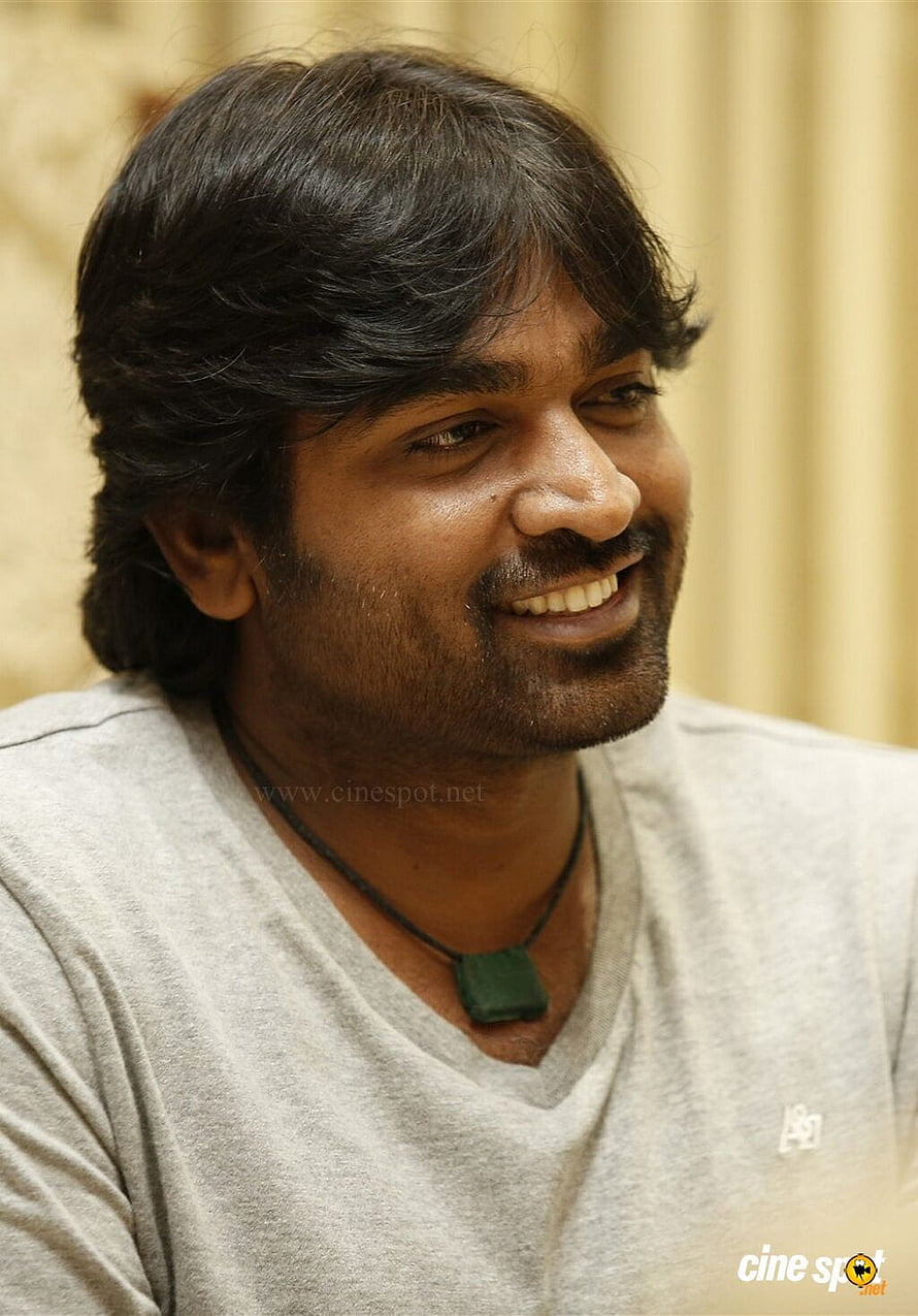 Vijay Sethupathi smiling portrait in casual grey t-shirt and green pendant necklace HD phone wallpaper