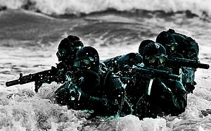 MARCOS Commandos in Tactical Gear Advancing Through Rough Ocean Waves HD wallpaper