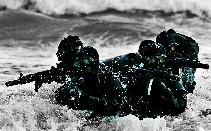 MARCOS Commandos in Tactical Gear Advancing Through Rough Ocean Waves HD wallpaper