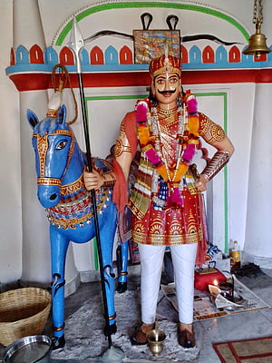 Jahar Veer Goga Ji Statue with Blue Horse and Traditional Indian Temple Decor HD phone wallpaper