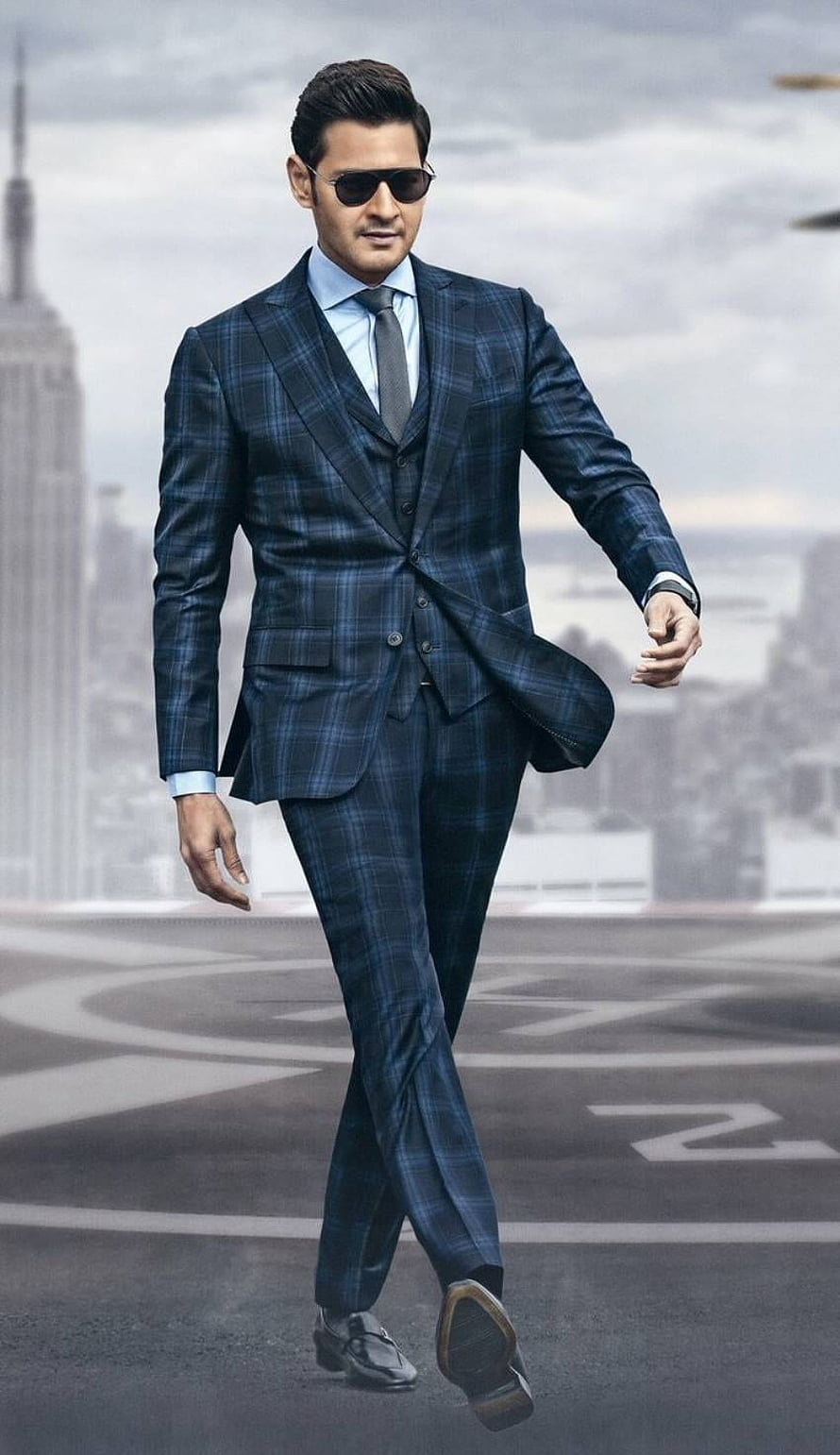 Mahesh Babu in a navy plaid three-piece suit and sunglasses on a city rooftop HD phone wallpaper