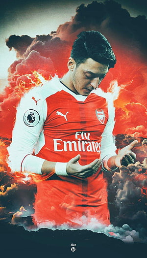Mesut Özil in Arsenal Home Kit with Dramatic Fiery Cloud Background HD phone wallpaper