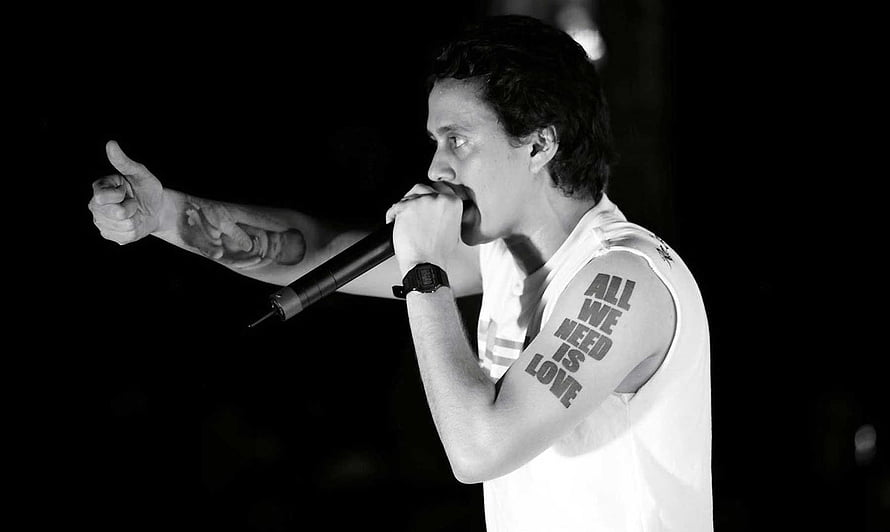 Canserbero performing live on stage in black and white HD wallpaper