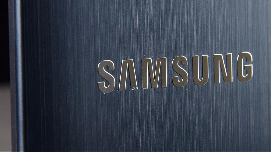Close-up of the Samsung brand logo on a brushed metal surface HD wallpaper