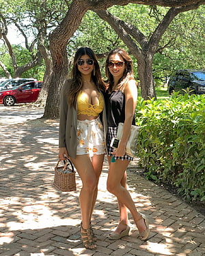 Mia Khalifa and friend posing in summer fashion on a tree-lined cobblestone path HD phone wallpaper