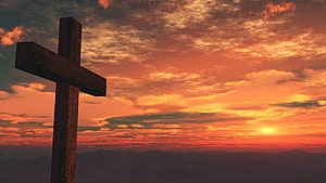 Wooden Cross Silhouette Against Vibrant Orange Sunset Sky With Distant Mountains HD wallpaper
