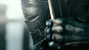 Close-up of a medieval knight's helmet with a cross emblem and chainmail armor HD wallpaper