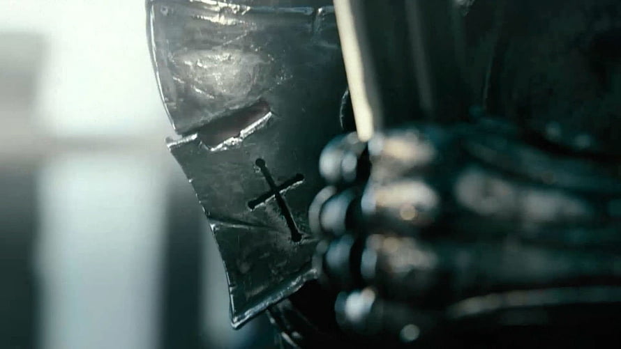 Close-up of a medieval knight's helmet with a cross emblem and chainmail armor HD wallpaper