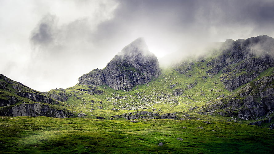 Misty Mountain Peak Rising Above Lush Green Highland Valley HD wallpaper
