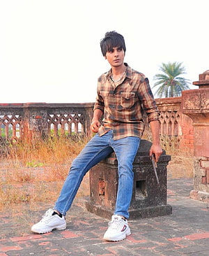 Jay Randhawa in Plaid Shirt and Jeans at Historic Red Sandstone Ruins HD phone wallpaper
