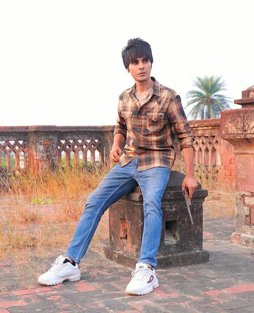 Jay Randhawa in Plaid Shirt and Jeans at Historic Red Sandstone Ruins HD phone wallpaper