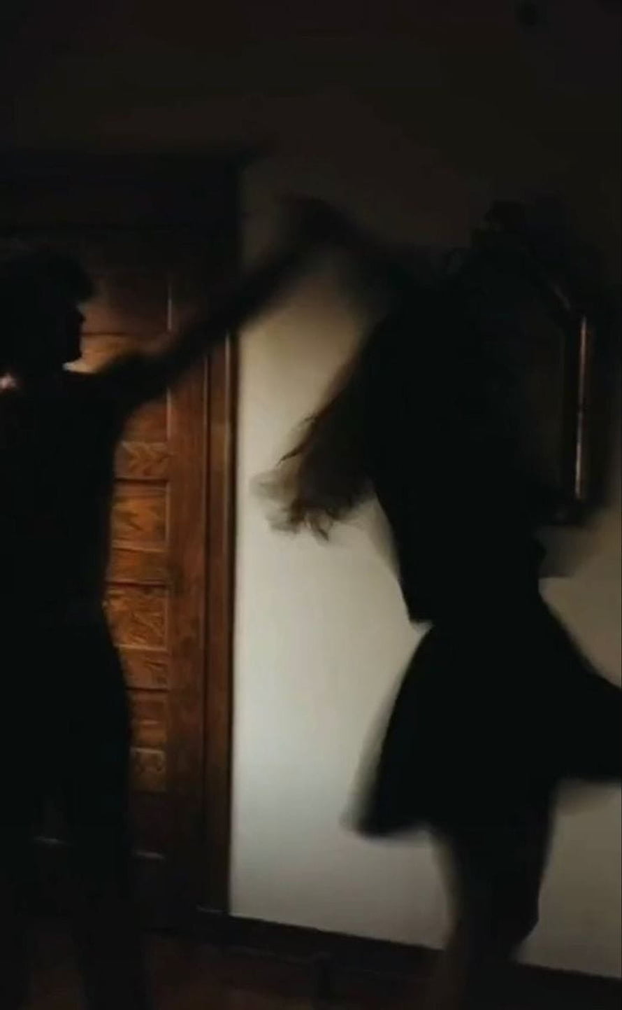 Dark Aesthetic Silhouette of a Couple in Motion Against a Wooden Door HD phone wallpaper