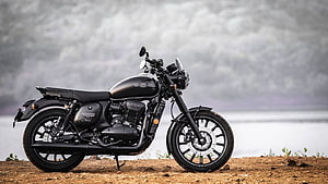 Jawa 42 Matte Black Motorcycle Parked on Gravel Shoreline with Misty Water Background HD wallpaper