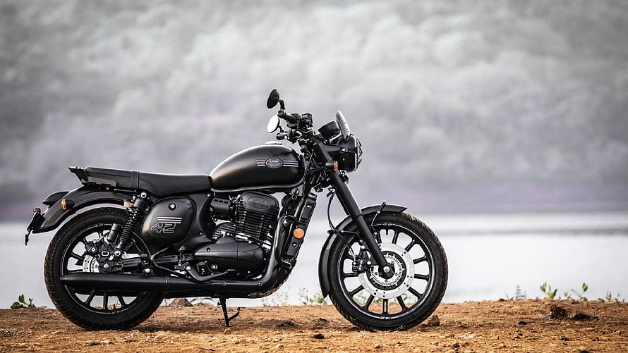 Jawa 42 Matte Black Motorcycle Parked on Gravel Shoreline with Misty Water Background HD wallpaper