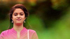 Keerthi Suresh in Pink Traditional Attire with Silver Earrings and Green Background HD wallpaper