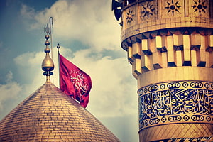 Karbala Shrine Dome and Minaret with Red Flag Against Cloudy Sky HD wallpaper