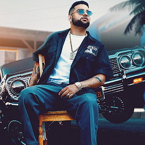 Karan Aujla in a Black Shirt and Sunglasses Seated in Front of a Classic Car HD phone wallpaper