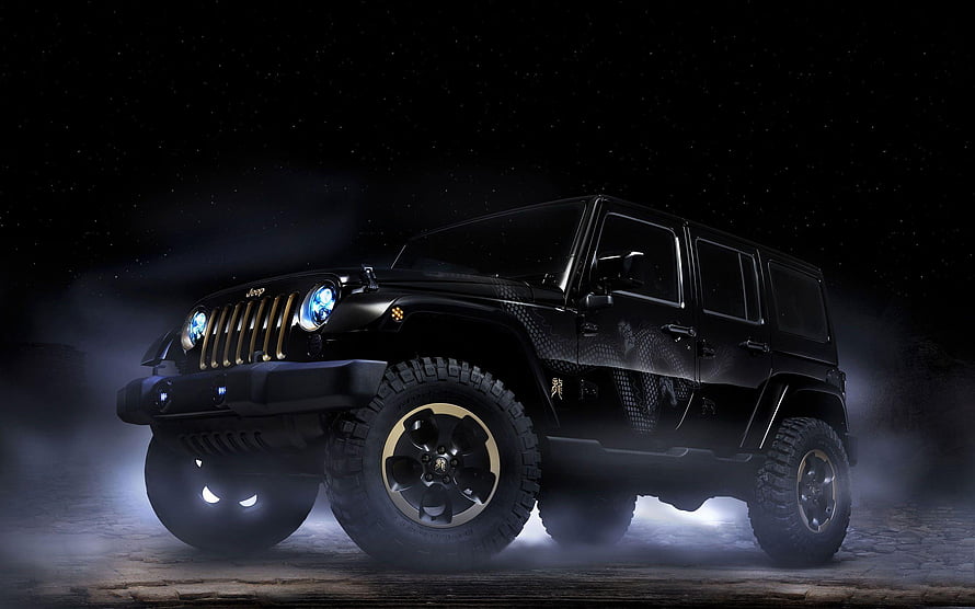 Black Jeep Wrangler with Gold Accents in Dramatic Night Setting HD wallpaper