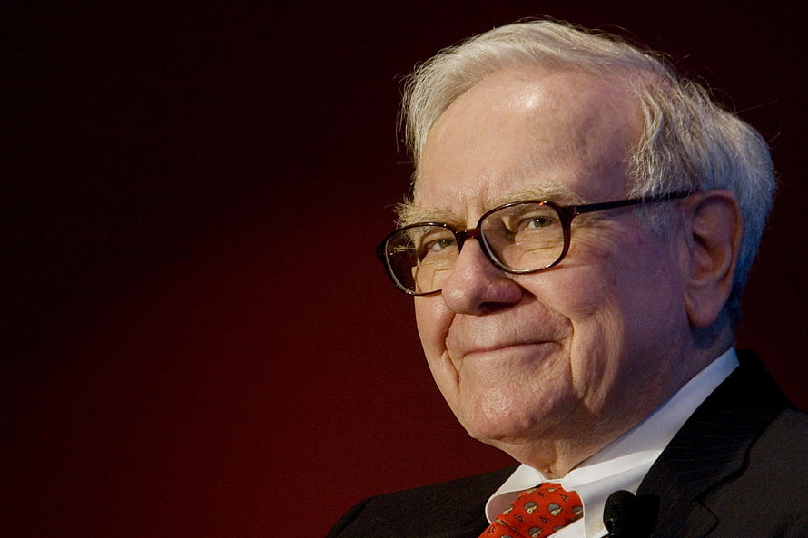 Warren Buffett in a dark suit and red tie against a deep red background HD wallpaper