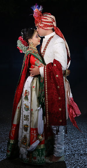 Traditional South Indian Wedding Couple in Vibrant Red and White Attire HD phone wallpaper