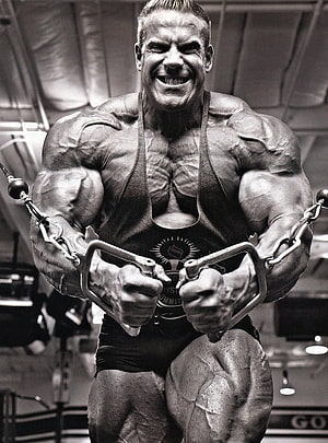 Jay Cutler Performing Cable Fly in Black and White Gym Portrait HD phone wallpaper