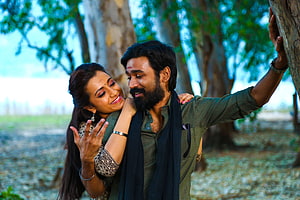 Dhanush and Trisha in an intimate outdoor scene from the Tamil film Kodi HD wallpaper