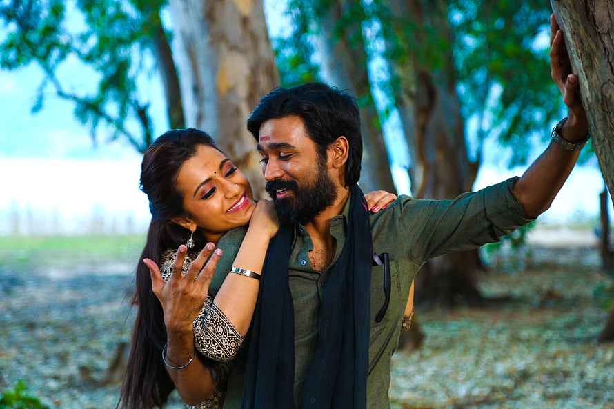Dhanush and Trisha in an intimate outdoor scene from the Tamil film Kodi HD wallpaper