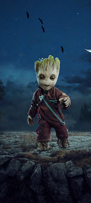 Baby Groot Standing on Rocky Terrain Under a Starry Night Sky with Bats Flying Overhead HD phone wallpaper