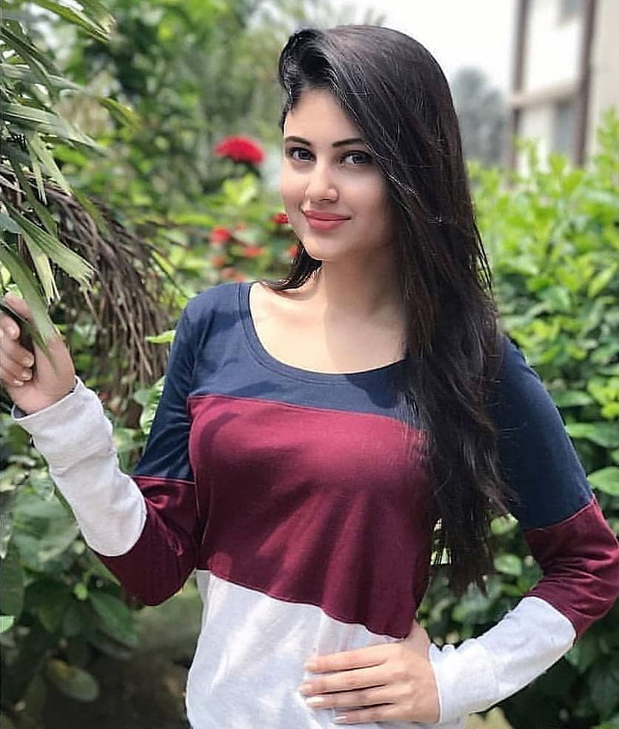 Young woman with long dark hair in a color-blocked top standing in a lush garden, Top 100 Hottest Desi Girls of Pakistani Indian Girls, #indian girls HD phone wallpaper