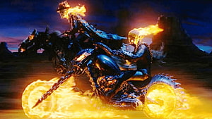 Ghost Rider and Carter Slade on flaming motorcycles racing through a dark desert landscape HD wallpaper