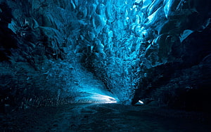 Mystic Blue Ice Cave Interior With Glowing Passage And Textured Frozen Walls HD wallpaper