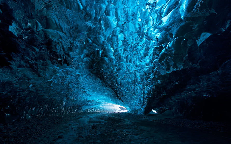 Mystic Blue Ice Cave Interior With Glowing Passage And Textured Frozen Walls HD wallpaper