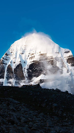 Mount Kailash Snow-Capped Peak Rising Above Rocky Terrain Under a Clear Blue Sky HD phone wallpaper