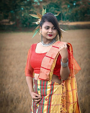 Santali Woman in Traditional Attire with Floral Hairpiece in a Golden Field HD phone wallpaper