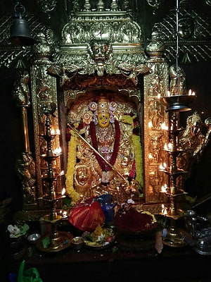 Kanakadurga Devi Temple Shrine in Vijayawada with Oil Lamps and Floral Offerings HD phone wallpaper