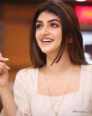 Sree Leela smiling portrait in a cream blouse with a delicate pendant necklace HD phone wallpaper