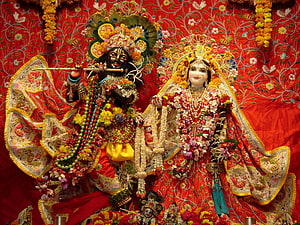 Ornate Krishna and Radha Temple Deities Adorned in Flowers and Jewels HD wallpaper