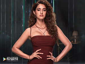 Disha Patani in a deep red strapless dress with curly hair and gold jewelry HD wallpaper
