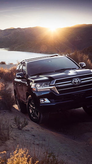 Black Toyota Land Cruiser Heritage Edition parked on a rugged trail at sunset HD phone wallpaper